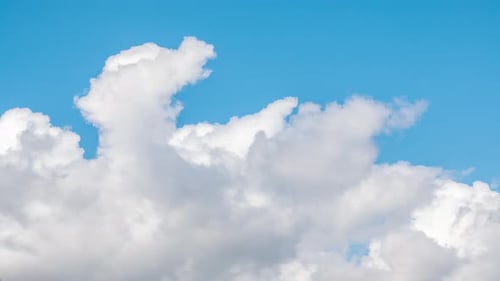 Clouds Drifting Across a Bright Blue Sky