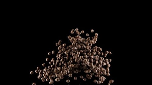 Brown Objects Propelled Upwards on Black Background