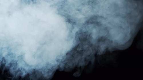 White Smoke Billows Across Black Background Texture
