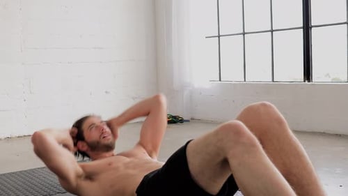 Fit Man Doing Crunches in Bright Studio