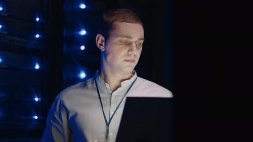 IT Technician in Data Center Digital Server Room Controlling Work of Rack Server Cabinets with a