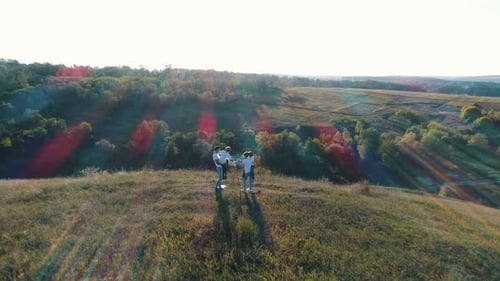 Family Painting Together Outdoors on Hilltop Aerial View