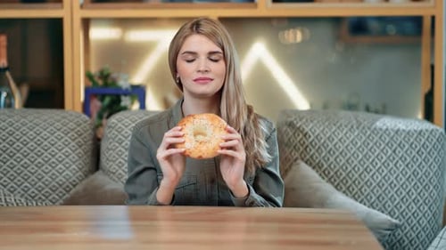 Woman Eats Flatbread at Restaurant and Smiles