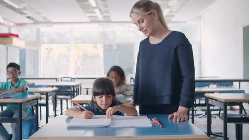 Teacher Helping Student in Classroom Setting