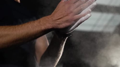 Hands Clapping with Chalk Powder in Gym