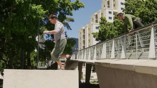 Young Adults Practicing Parkour in Urban Park