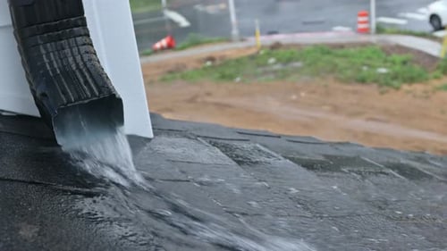 Rain Storm with House Roof Rainwater Flows Down the Roof