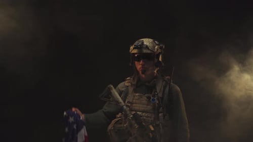 Sole Soldier Holding American Flag Amid Smoke
