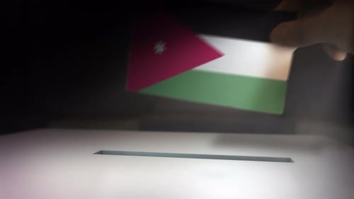 Hand Inserting Flag into Ballot Box