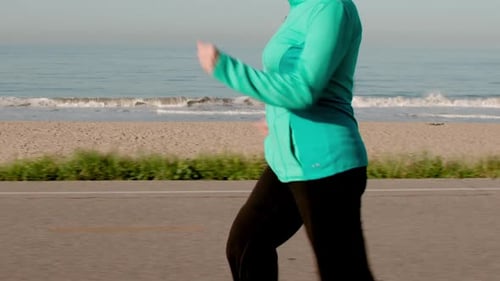 Senior Woman Exercising At The Beach