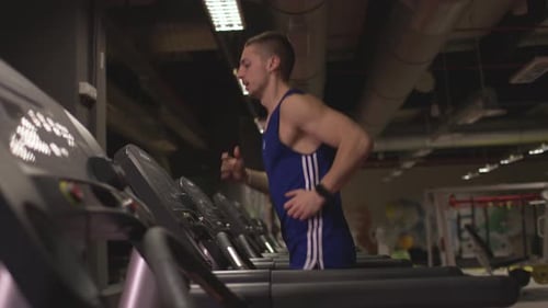 Man running on treadmill at gym