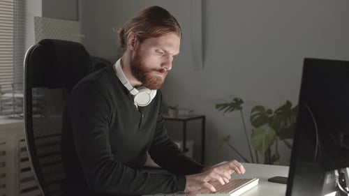 Serious Programmer Working at Night