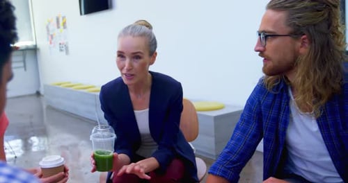 Colleagues Chatting During Break in Modern Office