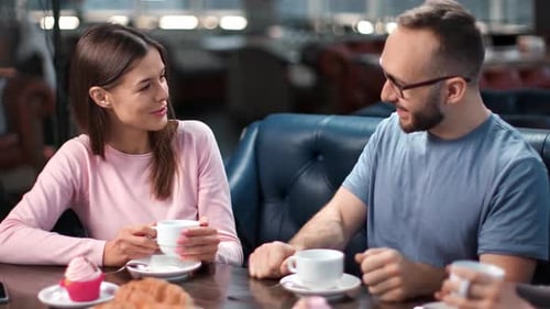 Smiling Couple Enjoying Romantic Meeting at Cafe Talking Together