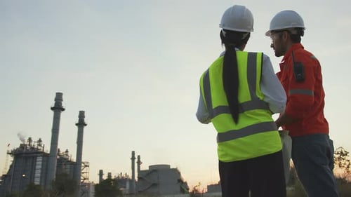 Engineers Reviewing Plans at Industrial Plant