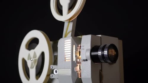 Vintage Film Projector with Reels Turning on Black