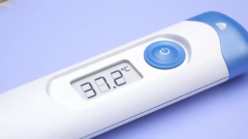Closeup view at a thermometer with rising temperature value. Pills. Fever. 4KHD
