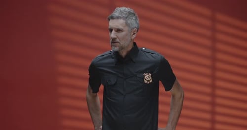 Man in Uniform with Serious Expression Stares Ahead