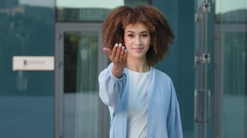 Woman Beckons the Viewer in an Urban Setting