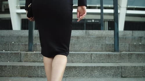 Woman Ascending Steps in City Elegant Business Attire