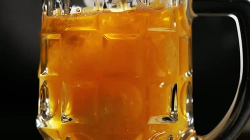 Beer Pouring into Glass Mug in Macro Shot