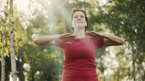 Active Senior Woman Exercising in Sunny Green Park