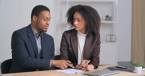 Business Professionals Reviewing and Signing Documents in Office