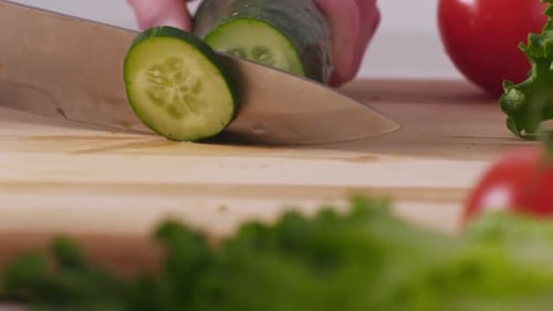 Slicing a Cucumber for Salad Preparation