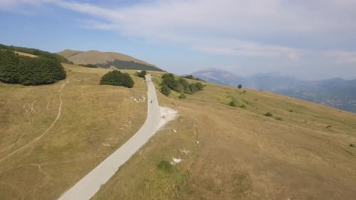 Aerial view of a man driving a motorbike on a mountain road