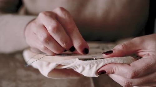 Close Up of Woman Embroidering in Home