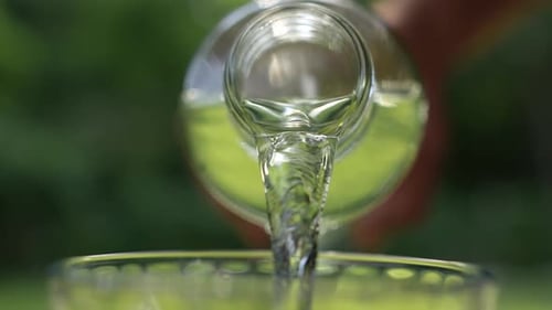 Liquid Pouring into Glass Outdoors