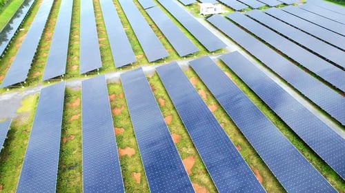 Drone fly over solar farm, renewable energy from solar.