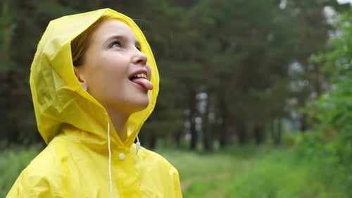 Girl in Yellow Raincoat Catches Raindrops