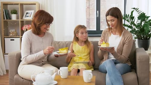 Three Generations Enjoying Cake Together at Home