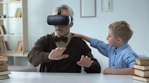Senior Man Using VR Headset with Grandson