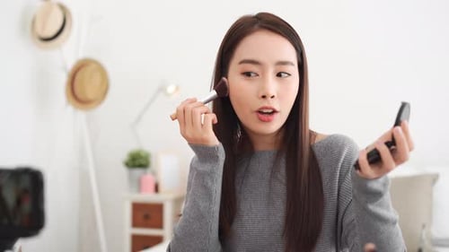 Woman Applies Makeup for Beauty Vlog