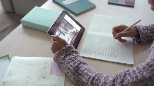 Girl Studies with Tablet and Online Video Lesson