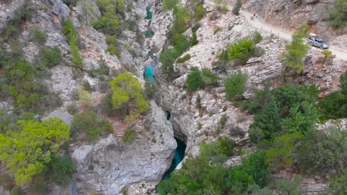 Flight Over a Mountain River and a Trail to a Gorge Among a Coniferous Forest