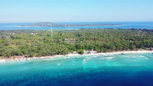 Aerial drone shot scenery of tranquil shore beach adventure by blue lagoon and white sand background