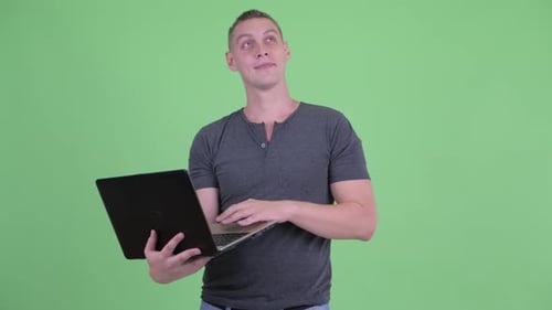 Man Typing on Laptop on Green Screen
