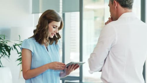 Business people working together on digital tablet in a modern office 4k