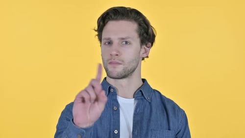 Young Adult Shakes Finger, Says No on Yellow