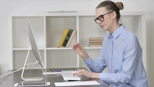 Focused Woman Working at Computer in Office
