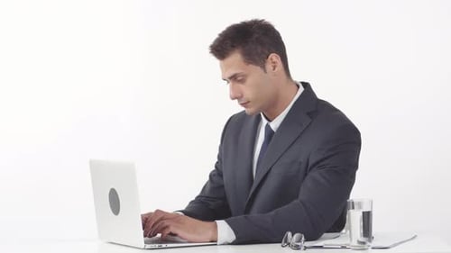 Focused Man Typing at Computer in Office