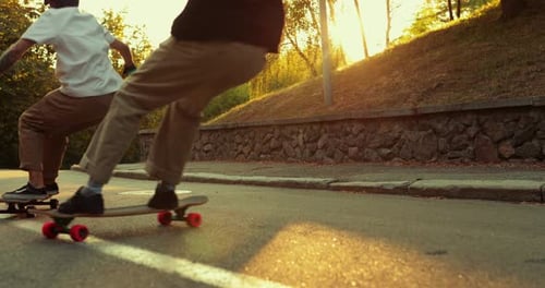 Two Guys Brake with Skates at Sunset.