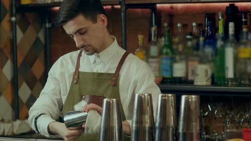 Barman Rub Metal Shakes with Napkin at Work Place