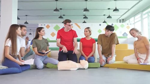 Group of Young Diverse People Practice First Aid Training By Hand