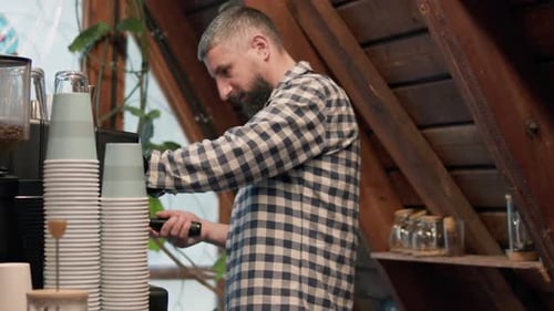 Barista Prepares Espresso at Stylish Coffee Counter