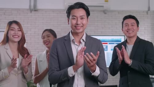 A group of colleagues are clapping their hands in congratulations.
