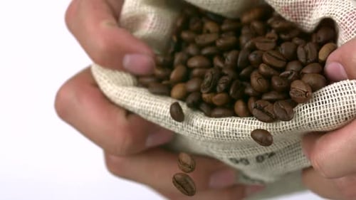 Hands Holding Bag Pouring Coffee Beans